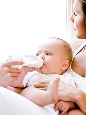 mother feeding bottle to baby